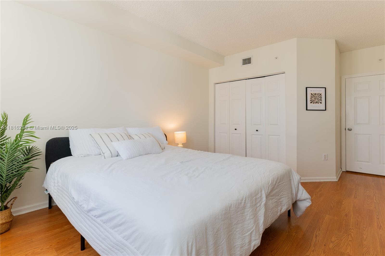 17100 North Bay Road, Unit PH1912 Sunny Isles Beach, FL 33160 - Photo 26 of 39 a bedroom with a bed and wooden floor