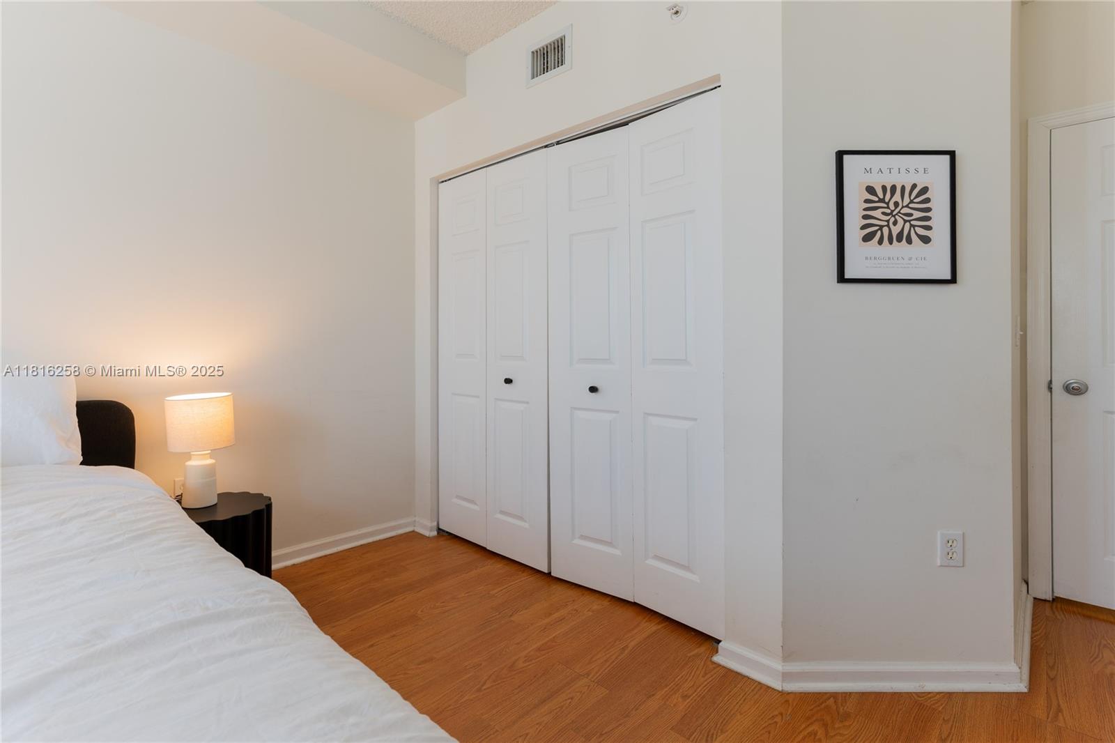 17100 North Bay Road, Unit PH1912 Sunny Isles Beach, FL 33160 - Photo 27 of 39 a bedroom with a bed and painting on the wall