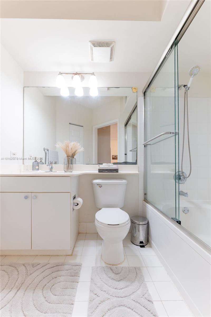 17100 North Bay Road, Unit PH1912 Sunny Isles Beach, FL 33160 - Photo 29 of 39 a bathroom with a toilet sink and shower