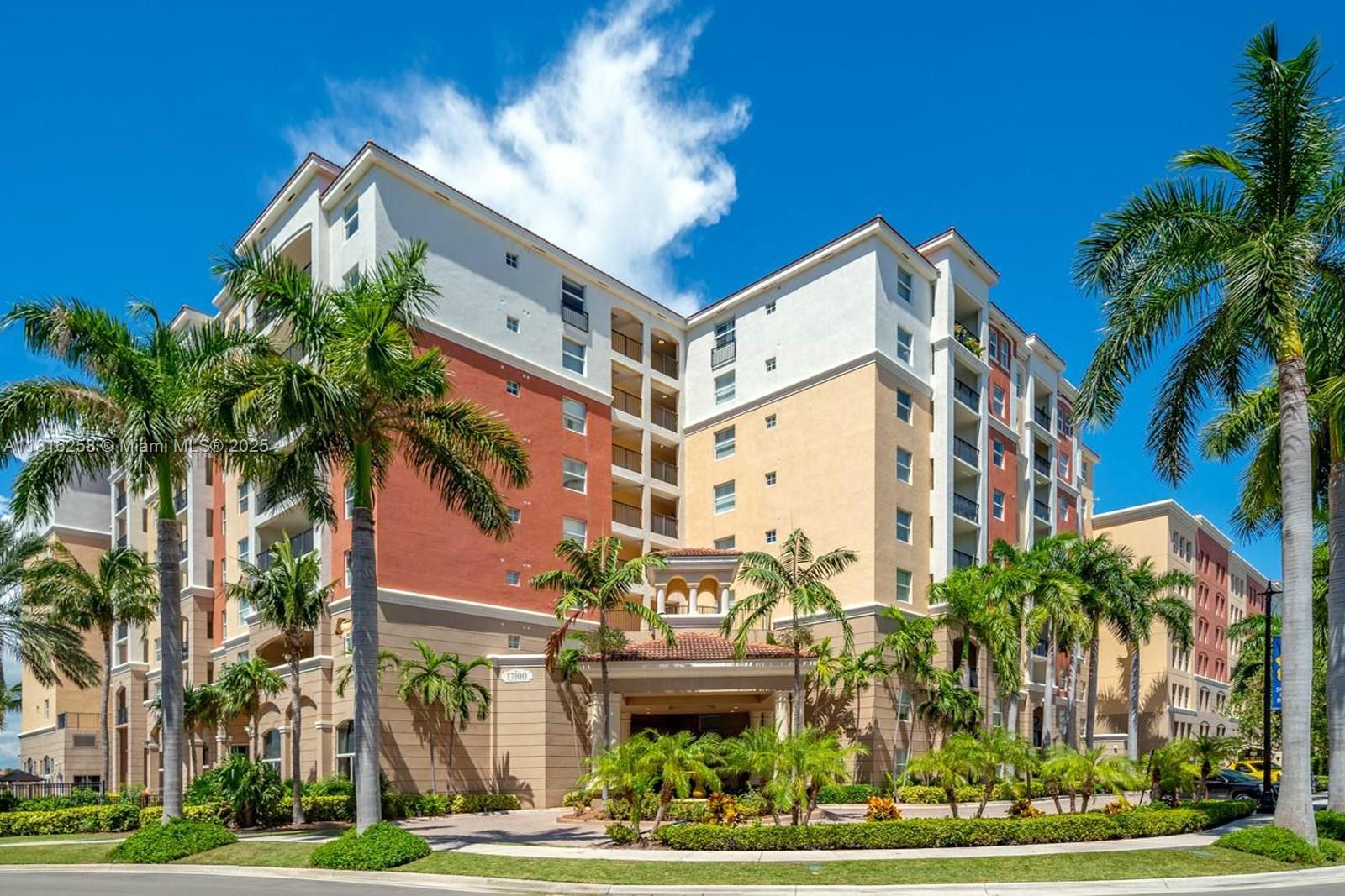 17100 North Bay Road, Unit PH1912 Sunny Isles Beach, FL 33160 - Photo 34 of 39 a front view of a multi story residential apartment building with yard and entryway