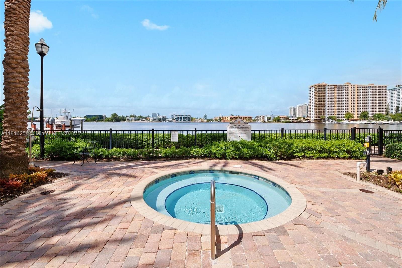 17100 North Bay Road, Unit PH1912 Sunny Isles Beach, FL 33160 - Photo 37 of 39 a swimming pool with outdoor seating and yard
