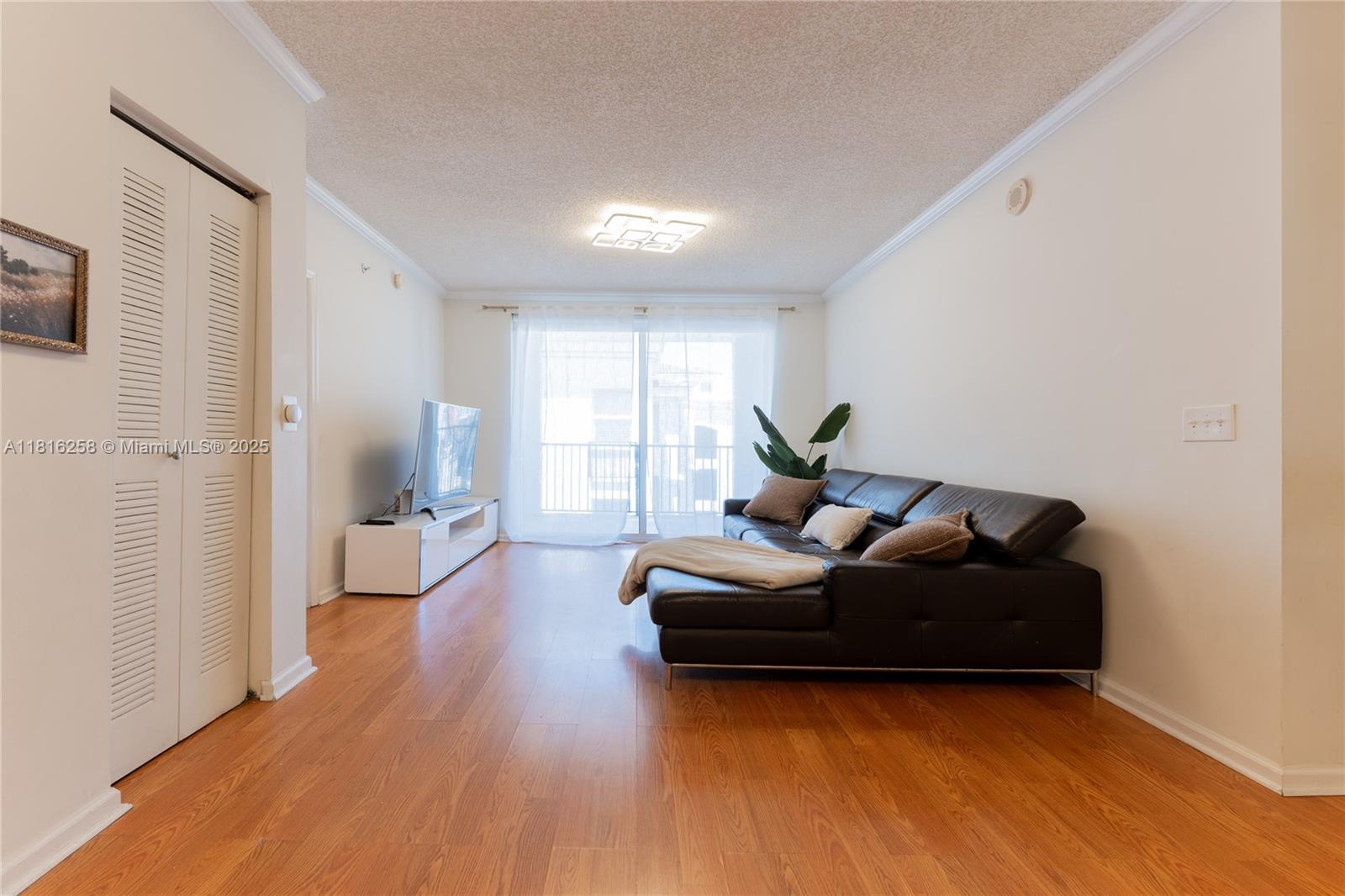 17100 North Bay Road, Unit PH1912 Sunny Isles Beach, FL 33160 - Photo 4 of 39 a living room with furniture and a wooden floor