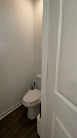 a white toilet sitting next to a shower
