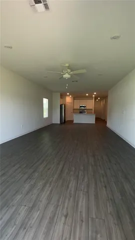 a view of a room with wooden floor