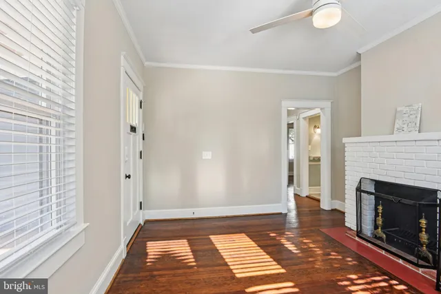 a view of a livingroom with a fireplace and window