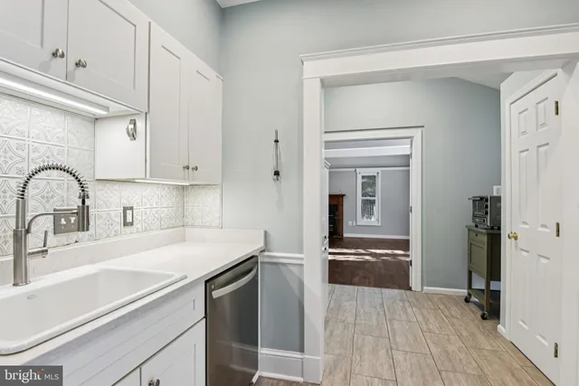 a kitchen with a sink and cabinets