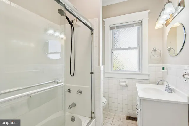 a bathroom with a sink a glass door and shower