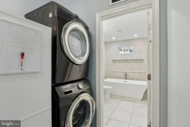 a view of a storage and utility room with washer and dryer