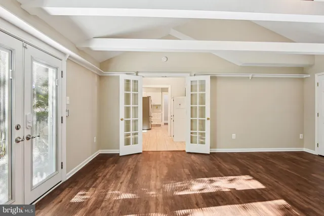 a view of a room with wooden floor and windows