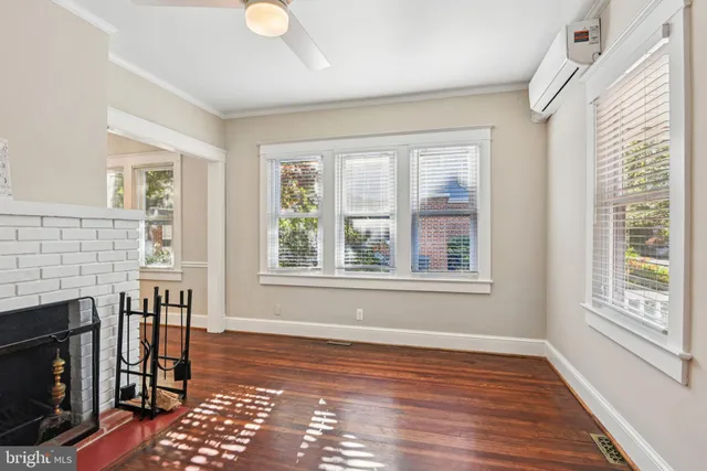 a view of empty room with wooden floor and fireplace