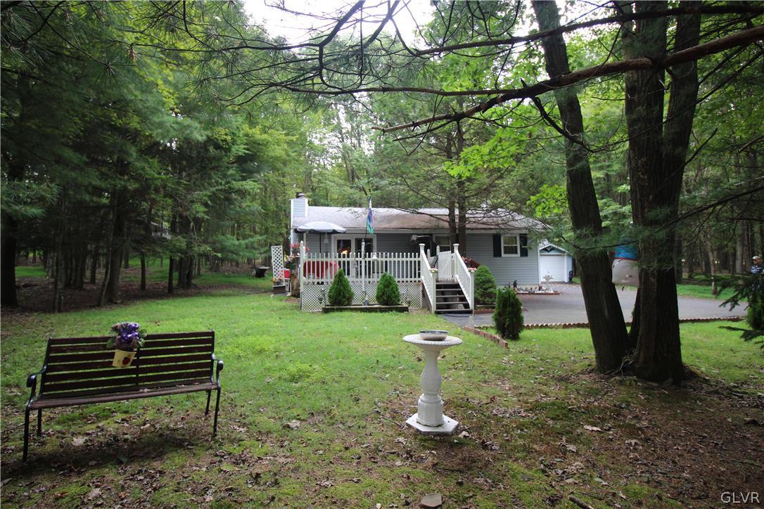 a view of a house with backyard sitting area and garden