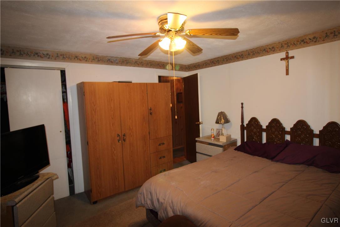 157 Maple Road Blakeslee, PA 18610 - Photo 12 of 19 a bedroom with a bed and a chandelier