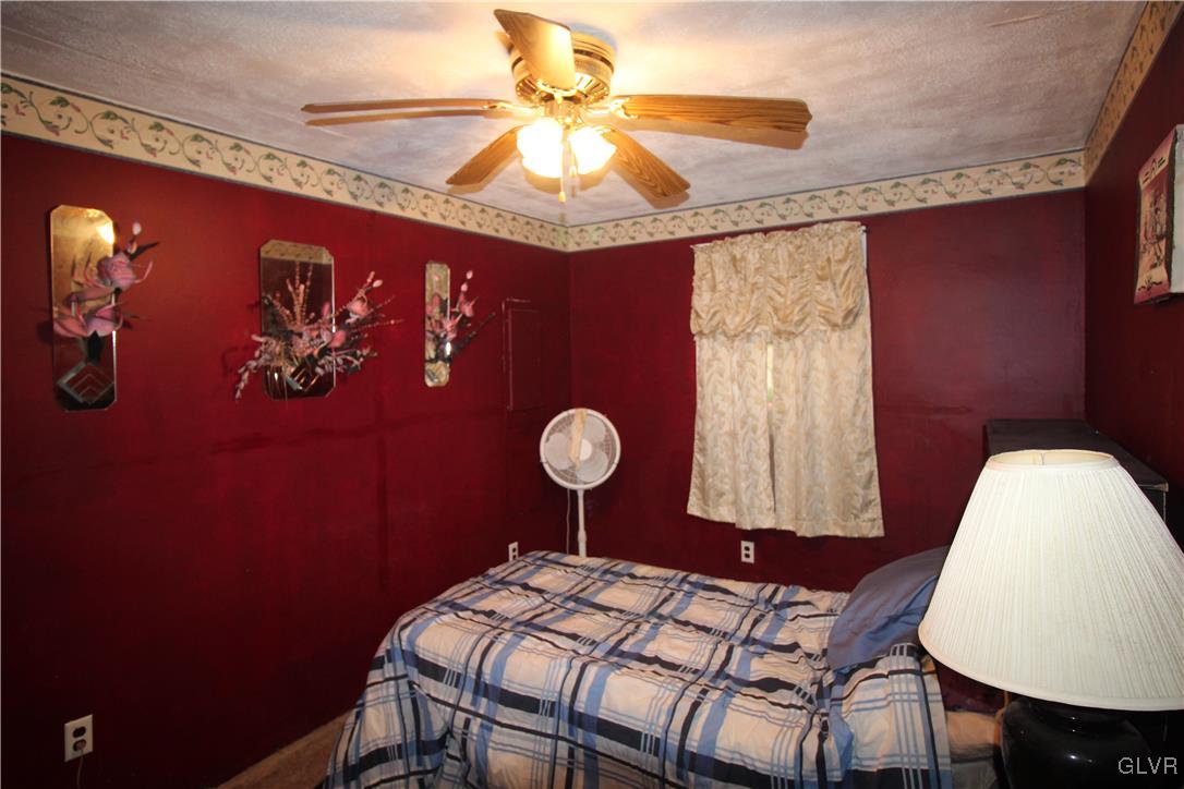 157 Maple Road Blakeslee, PA 18610 - Photo 13 of 19 a bedroom with a bed and a chandelier