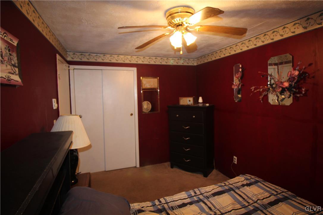 157 Maple Road Blakeslee, PA 18610 - Photo 14 of 19 a bedroom with a bed and a chandelier