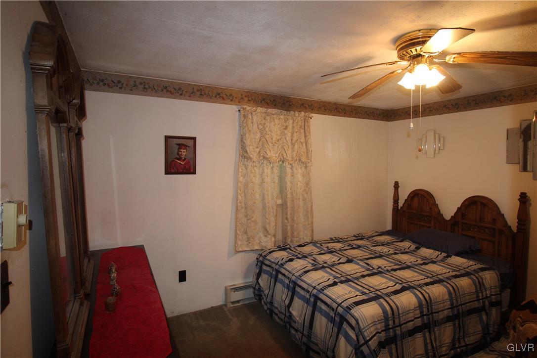 157 Maple Road Blakeslee, PA 18610 - Photo 15 of 19 a bedroom with a bed and a chandelier
