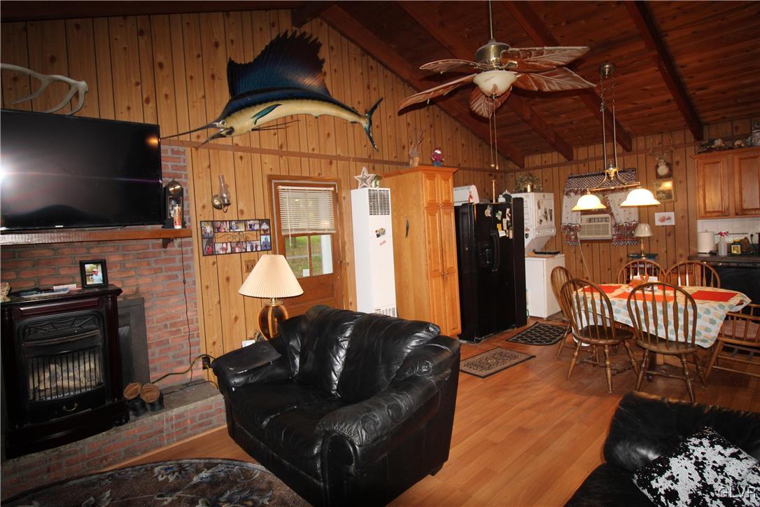 157 Maple Road Blakeslee, PA 18610 - Photo 5 of 19 a living room with furniture a flat screen tv and a fireplace