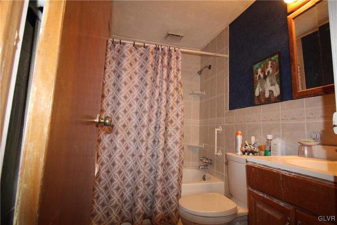 157 Maple Road Blakeslee, PA 18610 - Photo 10 of 19 a bathroom with a toilet and a shower curtain