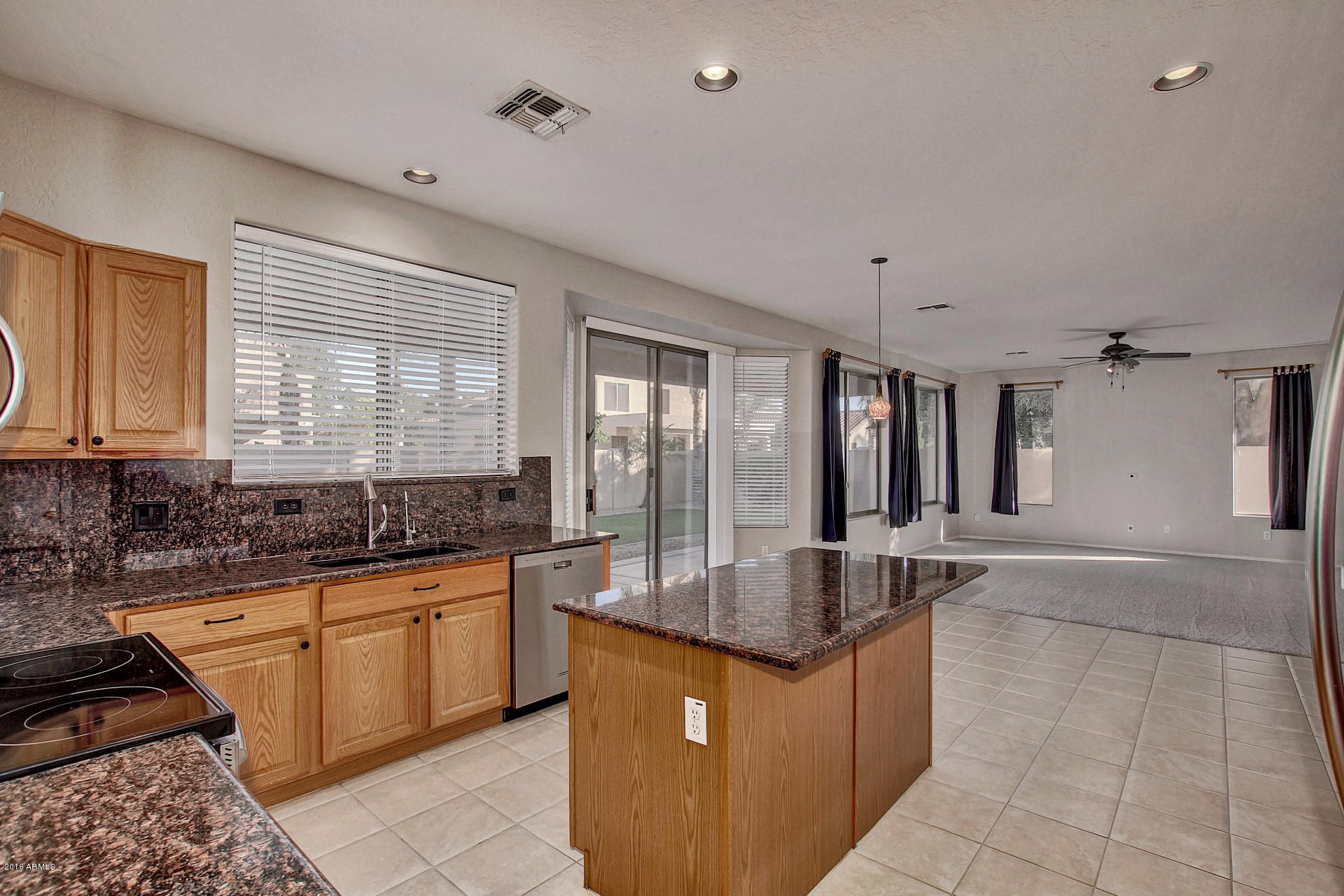 1360 East Harrison Street Gilbert, AZ 85295 - Photo 8 of 34 a large kitchen with granite countertop a sink and cabinets