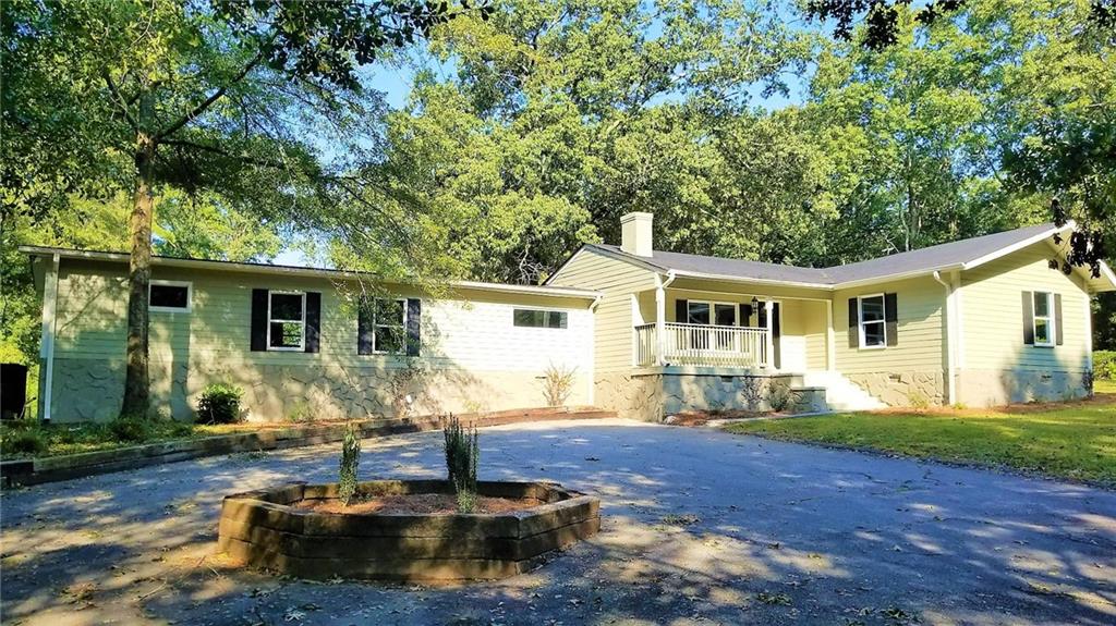 4337 Yates Road College Park, GA 30337 - Photo 1 of 1 a front view of house with yard furniture and tree