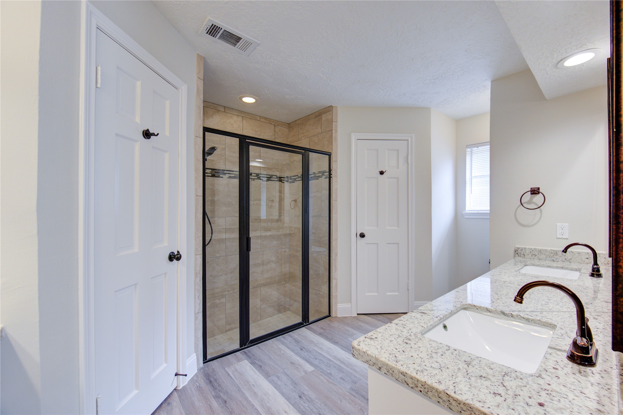 9115 Taidswood Drive Spring, TX 77379 - Photo 23 of 45 The primary bath offers two walk-in closets flanking the shower, a separate vanity area, and double sinks!