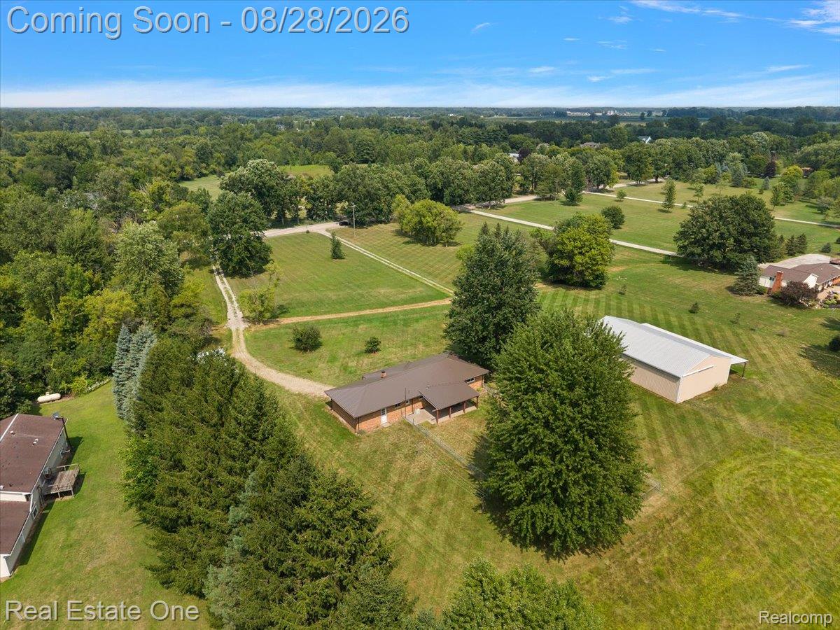 15250 34 Mile Road Armada, MI 48005 - Photo 15 of 49 Single-story residence with a brown metal roof, brick exterior, and covered front porch