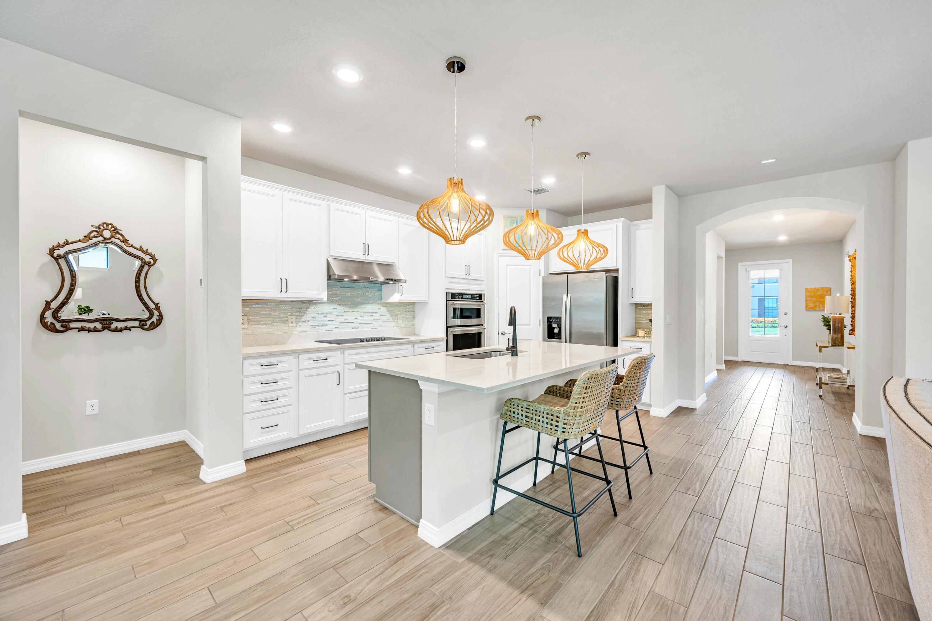 8028 Northwest 78th Street Tamarac, FL 33321 - Photo 7 of 38 a kitchen with stainless steel appliances granite countertop a sink cabinets and wooden floor