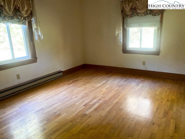 453 Smith Acres Road Ennice, NC 28623 - Photo 21 of 30 a view of an empty room and wooden floor