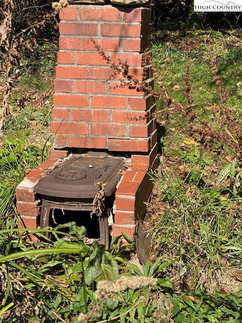 453 Smith Acres Road Ennice, NC 28623 - Photo 25 of 30 a bench sitting in front of a building