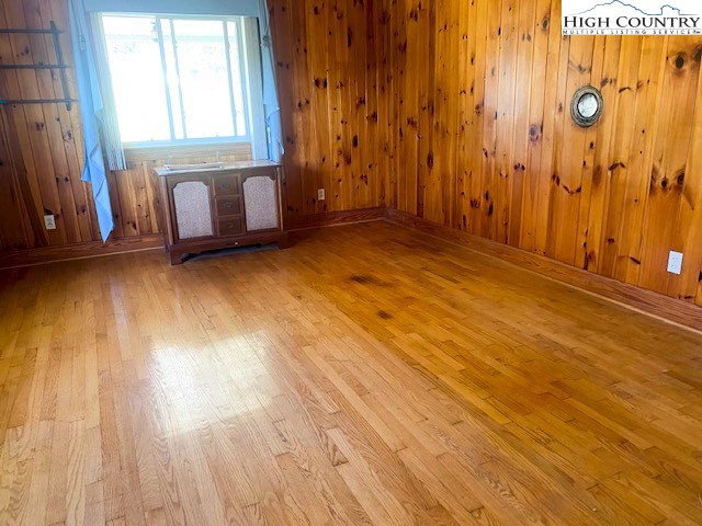 453 Smith Acres Road Ennice, NC 28623 - Photo 7 of 30 a view of an empty room with window and hardwood floor