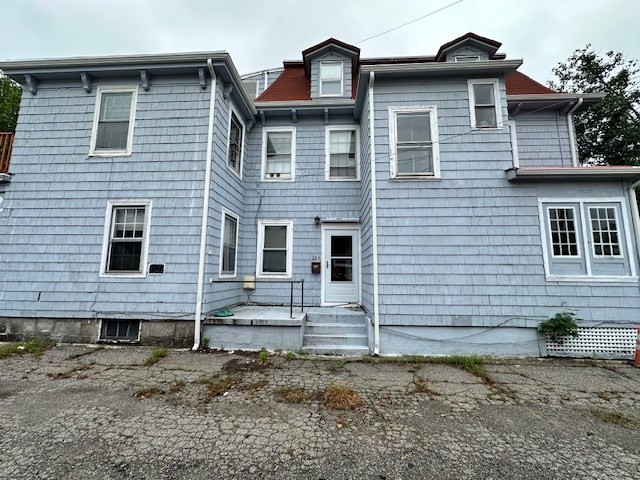13 Spruce Street, Unit A Waltham, MA 02453 - Photo 1 of 13 a front view of a house with garden