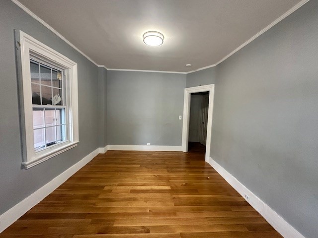 13 Spruce Street, Unit A Waltham, MA 02453 - Photo 13 of 13 a view of an empty room with wooden floor and a window