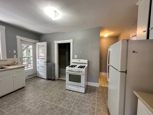 13 Spruce Street, Unit A Waltham, MA 02453 - Photo 2 of 13 a kitchen with a sink a refrigerator and a stove