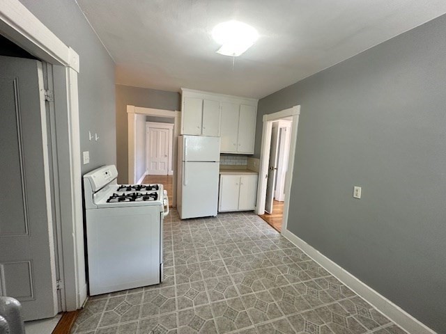 13 Spruce Street, Unit A Waltham, MA 02453 - Photo 3 of 13 a kitchen with stainless steel appliances a refrigerator and a stove