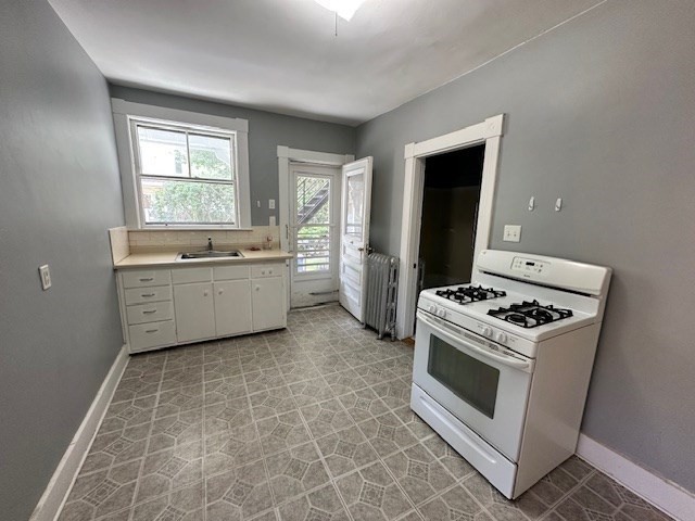 13 Spruce Street, Unit A Waltham, MA 02453 - Photo 4 of 13 a kitchen with a stove a sink and a window