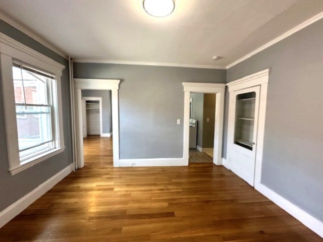 13 Spruce Street, Unit A Waltham, MA 02453 - Photo 6 of 13 a view of an empty room with wooden floor and a window