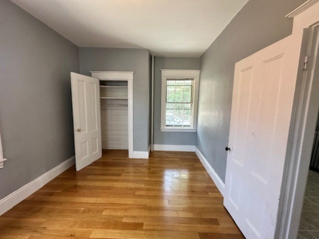 13 Spruce Street, Unit A Waltham, MA 02453 - Photo 9 of 13 a view of an empty room with closet and window