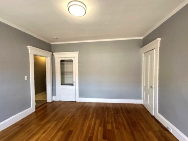 13 Spruce Street, Unit A Waltham, MA 02453 - Photo 10 of 13 an empty room with wooden floor and windows