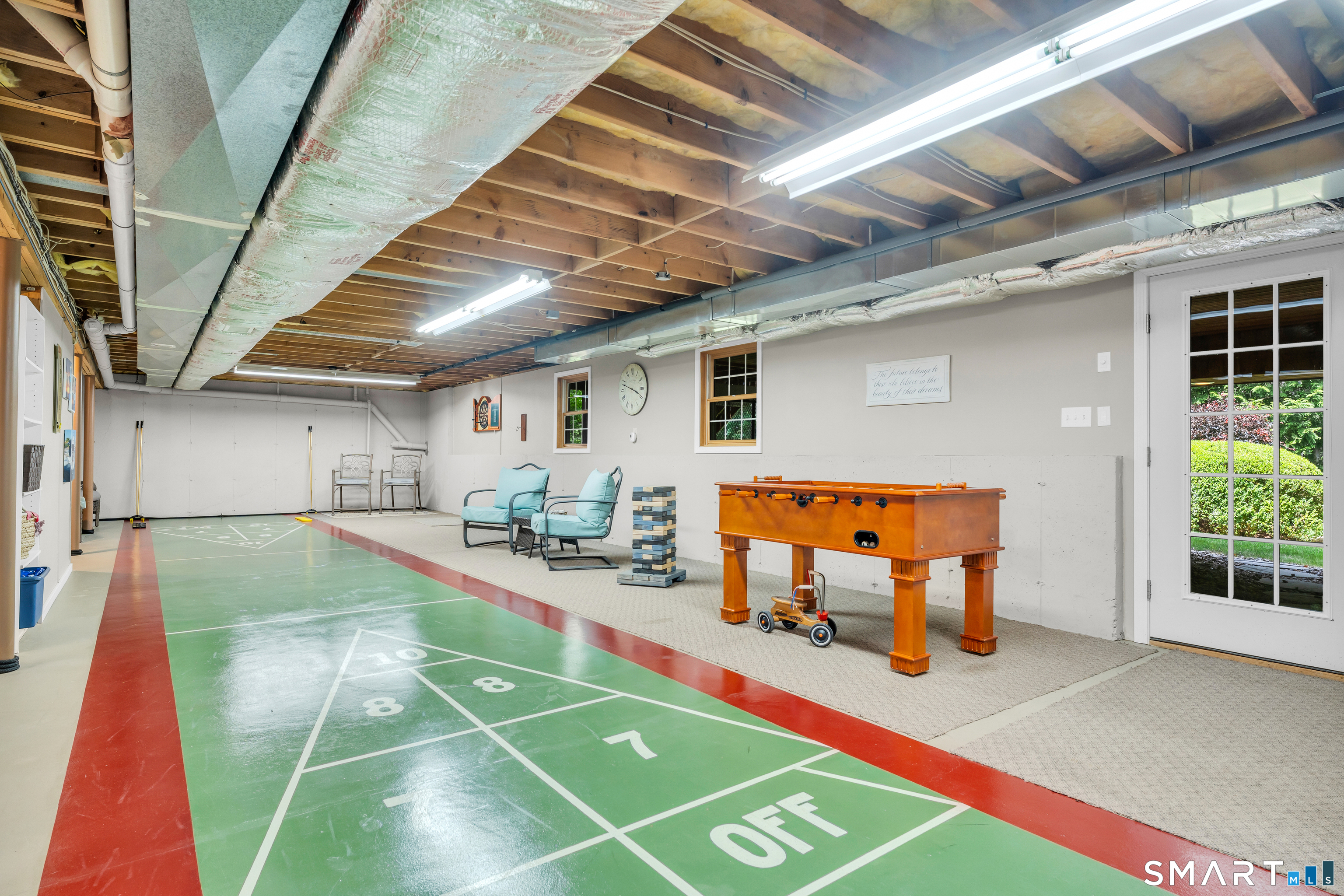11 Timber Lane Guilford, CT 06437 - Photo 32 of 39 The lower level /basement has full walk out and makes the perfect indoor game room shuffle board.