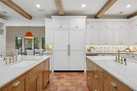 a kitchen with a sink window and cabinets