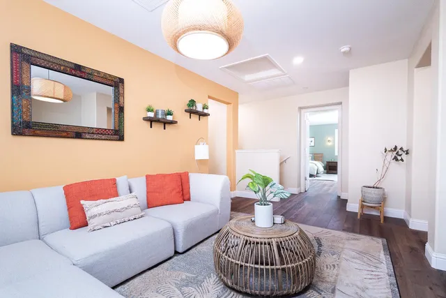 a living room with furniture and a potted plant