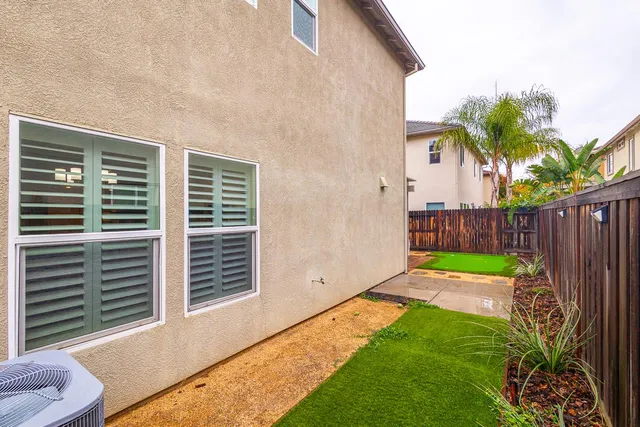 a front view of a house with a yard and a garage