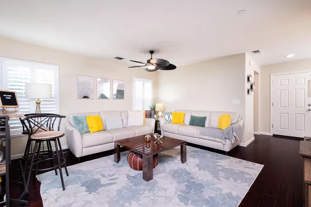 a living room with furniture and wooden floor