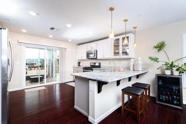 a kitchen with sink microwave and stove
