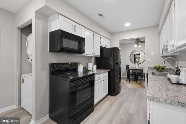 a kitchen with stainless steel appliances granite countertop a stove a refrigerator and a microwave