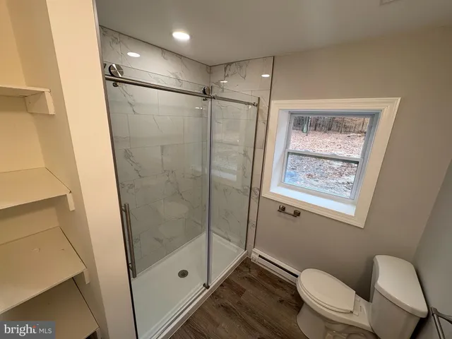 a bathroom with a shower a toilet and sink