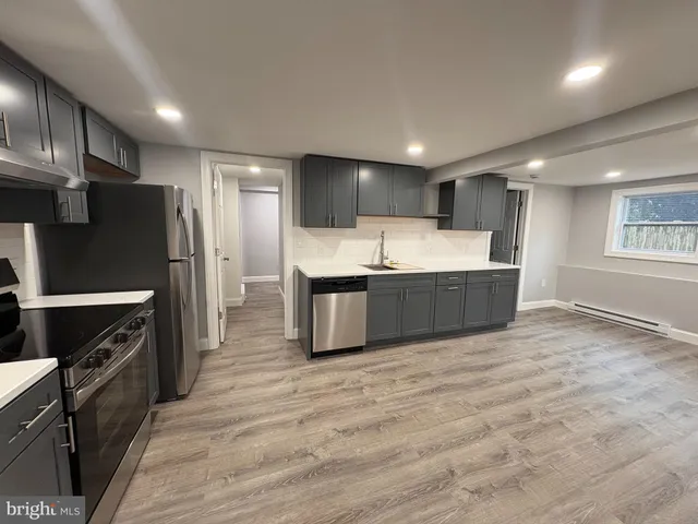 a kitchen with stainless steel appliances a refrigerator sink and cabinets