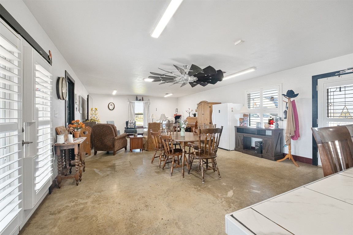 142 Zimmerhanzel Road Flatonia, TX 78941 - Photo 14 of 40 a living room with lots of furniture a chandelier a large window and a fireplace