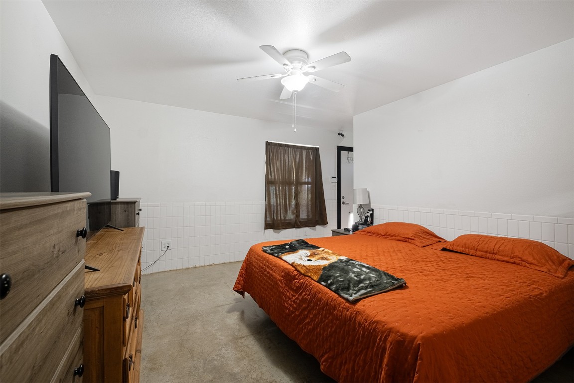 142 Zimmerhanzel Road Flatonia, TX 78941 - Photo 15 of 40 a bedroom with a bed and a chandelier