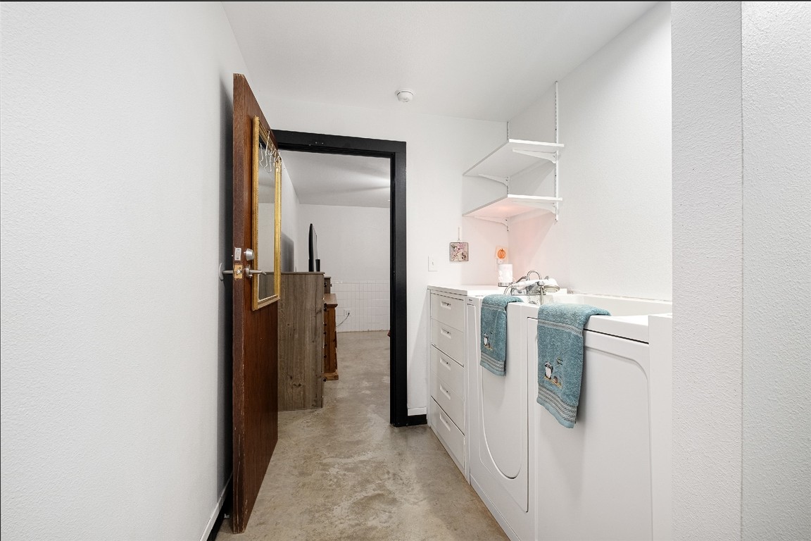 142 Zimmerhanzel Road Flatonia, TX 78941 - Photo 18 of 40 a view of a hallway with white cabinets and washer