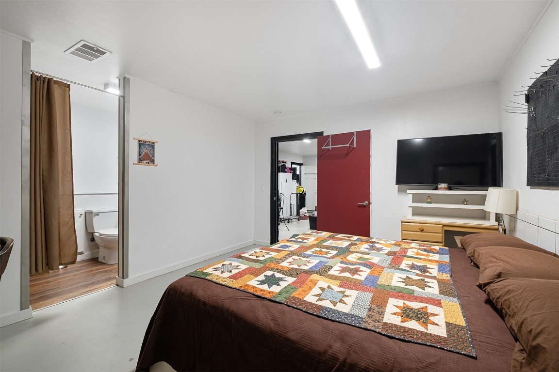 142 Zimmerhanzel Road Flatonia, TX 78941 - Photo 24 of 40 a bedroom with a bed and a flat screen tv